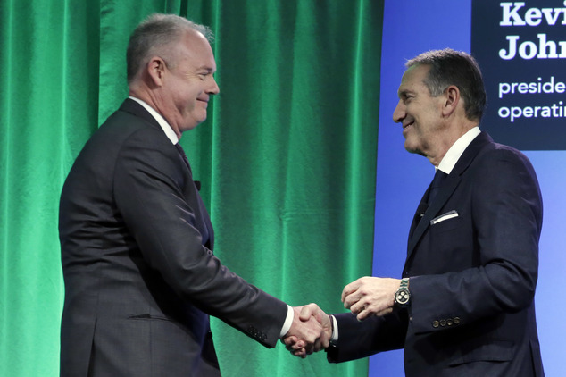 Starbucks Chairman and CEO Howard Schultz, right, introduces company President and COO Kevin Johnson during the Starbucks 2016 Investor Day meeting, in New York, Wednesday, Dec. 7, 2016. (AP Photo/Richard Drew)