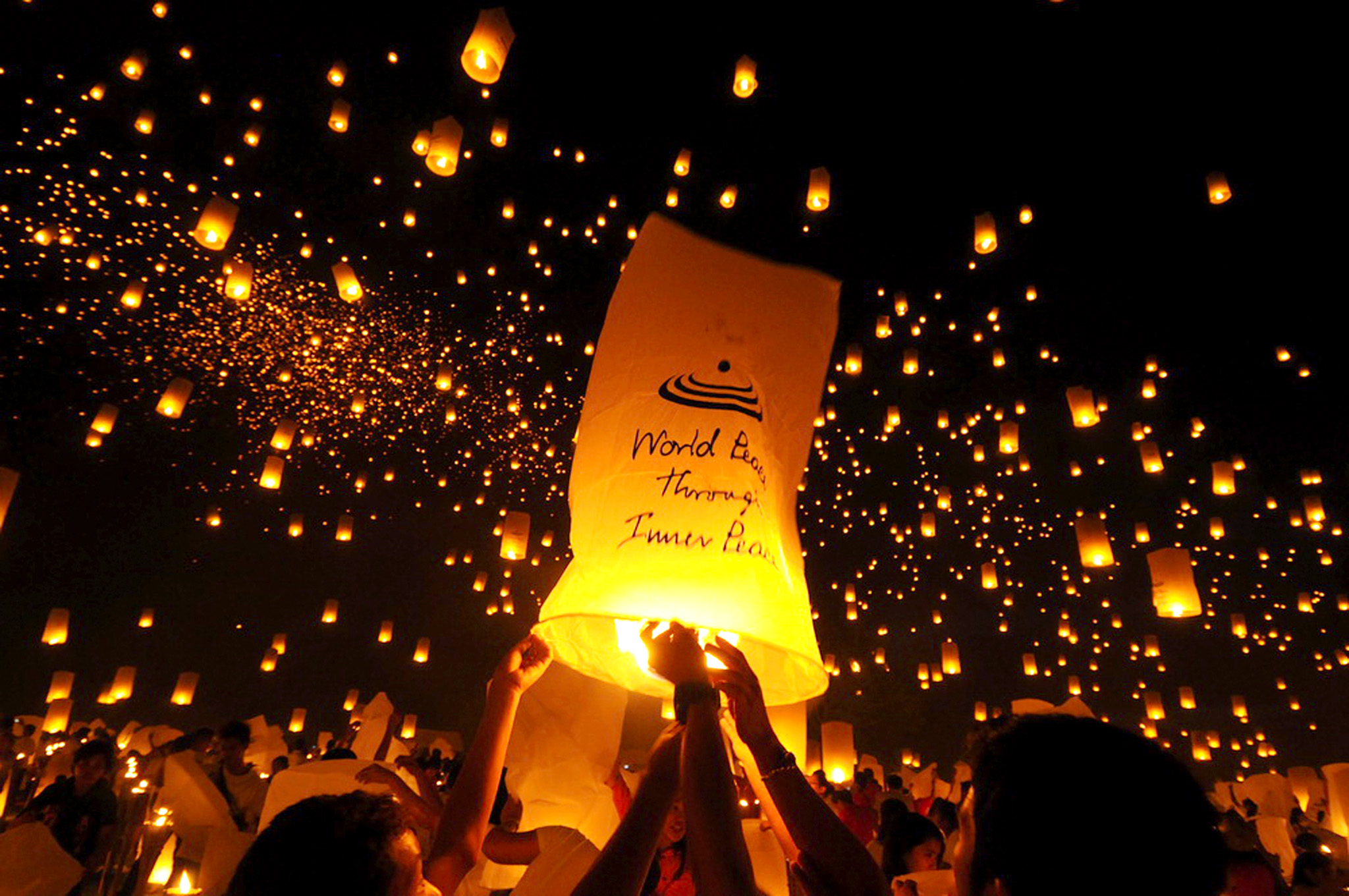 In this photo released by Middle Way Meditation Institute, Philippines, through Nutannan Srithorn, thousands of youths release into the sky paper lanterns to celebrate "World Peace Through Meditation" in an attempt to break a Guinness World Record Friday May 24, 2013 at the University of the Philippines campus at Miagao, Iloilo city in central Philippines. The organizers claimed to have released 15,185 sky lanterns breaking the current Guinness World Record of 12,740 sky lanterns released in a single event. The old record in 2012, the 12,740 sky lanterns were released in a single event in Romania during the opening of a shopping mall. (AP Photo/Wanlop Kiettijanon, Middle Way Meditation Institute, Philippines)